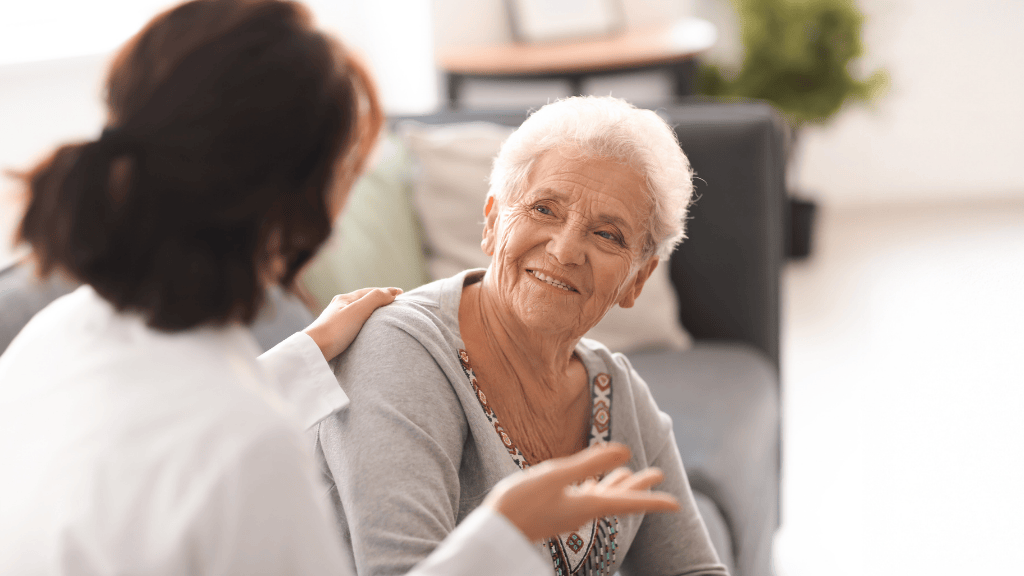 A senior woman smiling during a professional consultation about urinary incontinence treatment
