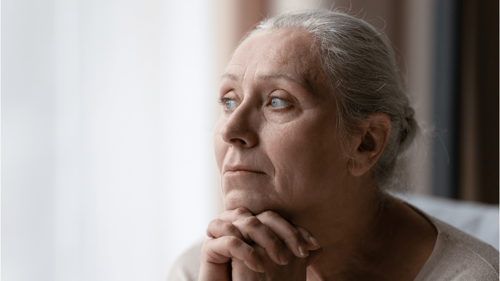 A thoughtful senior woman considering if mid-urethral sling surgery is the right solution for her urinary incontinence.