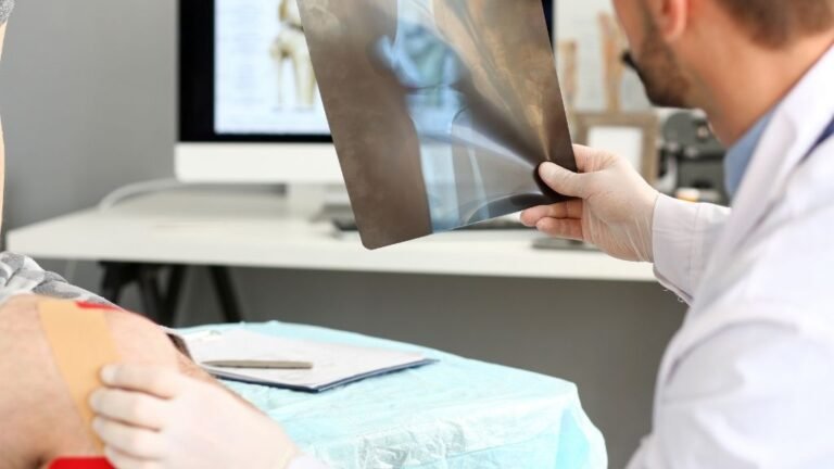 Orthopedic surgeon in Spain reviewing a knee scan with a patient