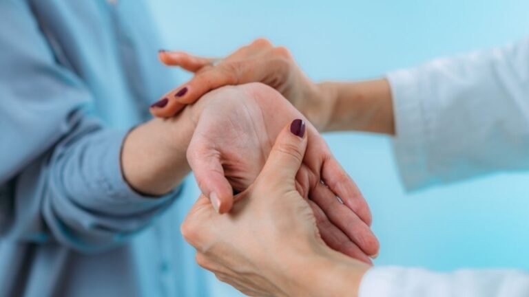 Doctor examining a patient’s wrist for carpal tunnel syndrome